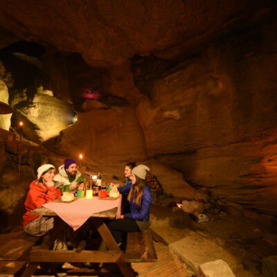 Group of people having lunch inside a cave in El Calafate