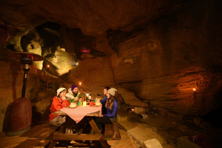 Group of people having lunch inside a cave in El Calafate