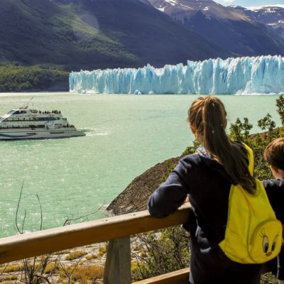 Two kids admiring the Perito Moreno Glacier from the catwalks inside the National Park.