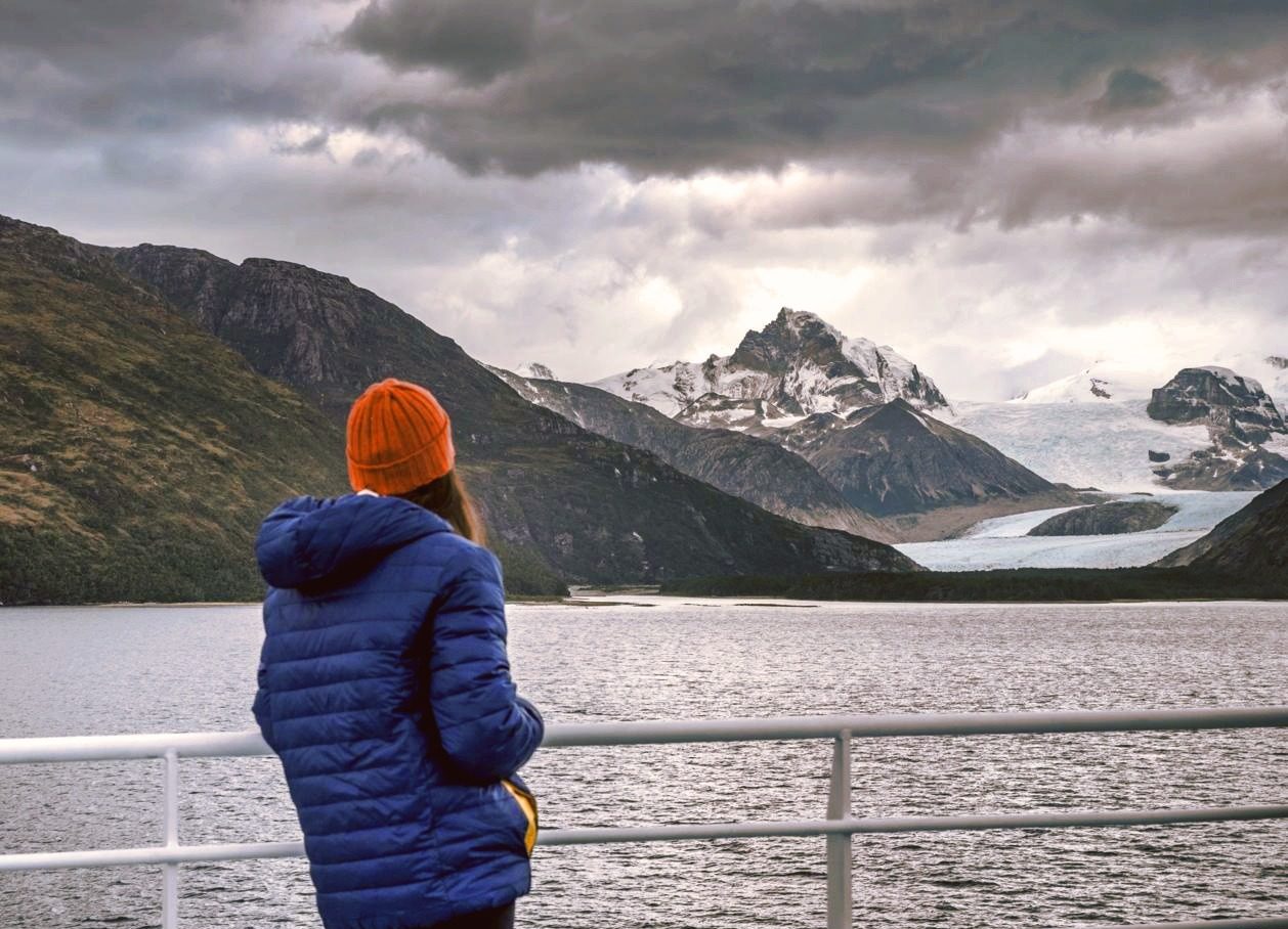 A passenger looking at Patagonia landscape from Australis Cruise