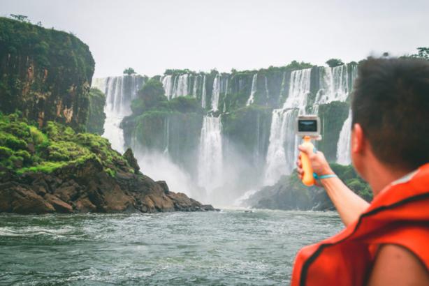 a guy taking photos of Iguazu Falls