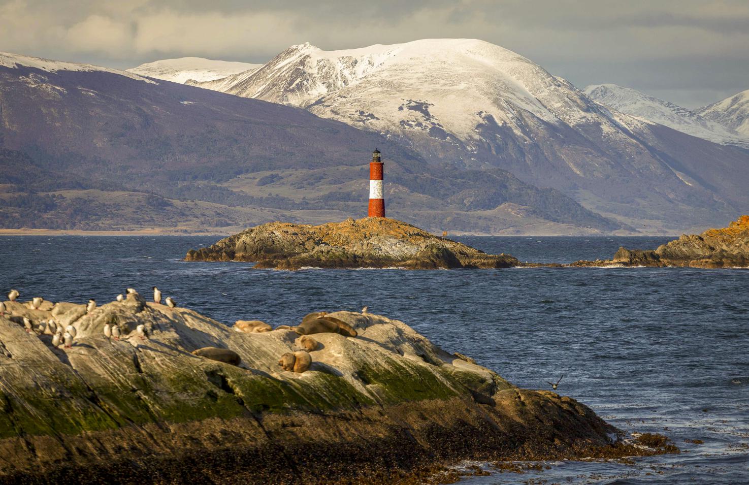 View of the Ushuaia Lighthouse from a boat excursion in Beagle Channel.