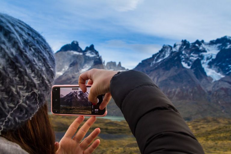 torres-del-paine-trekking (9) Woman taking a photo on Torres del Paine hike.