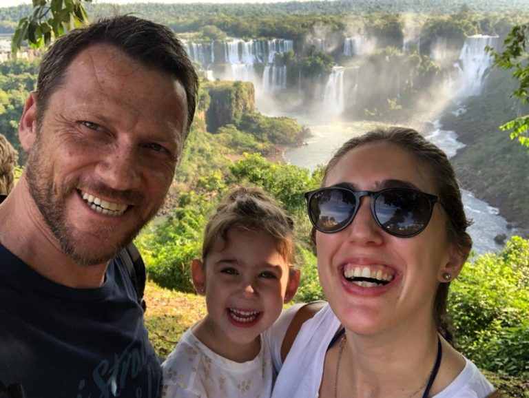 A happy family with Iguazú Falls as backdrop.