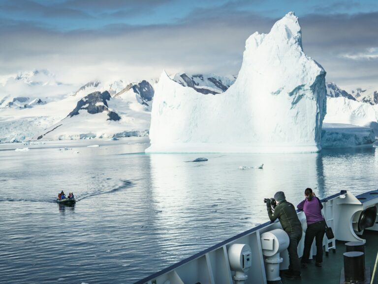 adventure-to-antarctica Passangers of an exploration to Antarctica admiring the landscape
