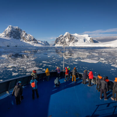 antarctica-cruise Front of antarctica cruise with people looking the landscape