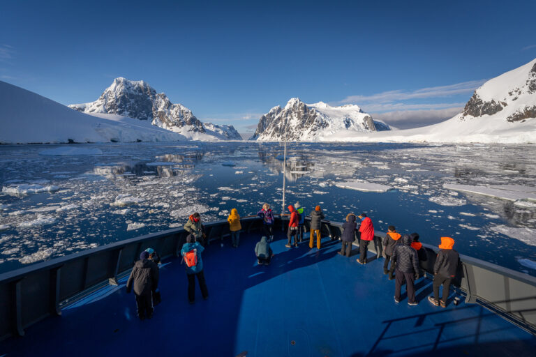 antarctica-cruise Front of antarctica cruise with people looking the landscape