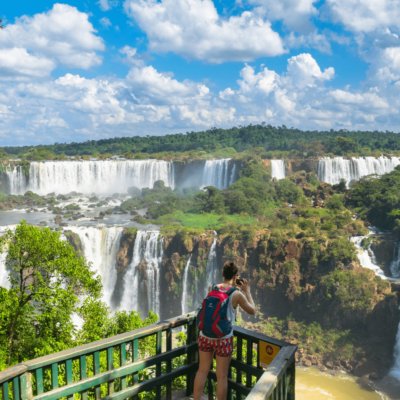 Person taking pictures of the Iguazú Falls from the walkways.